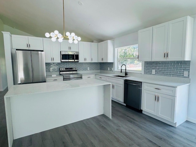215 Hollowbrook Cir, Daytona Beach, FL 32114 - kitchen with stainless steel appliances, a sink, vaulted ceiling, and white cabinetry