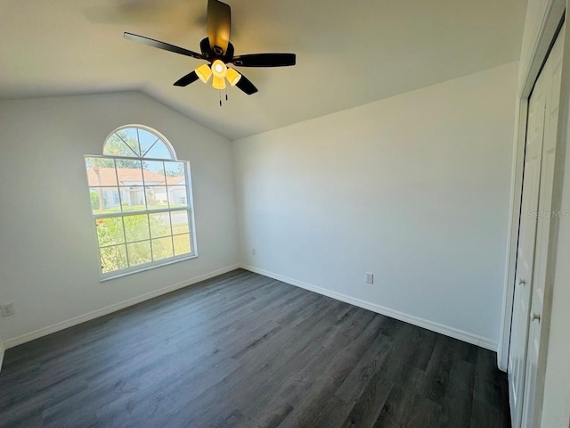 215 Hollowbrook Cir, Daytona Beach, FL 32114 - empty room with dark wood-type flooring, a ceiling fan, lofted ceiling, and baseboards