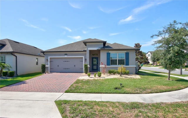 1727 Butterfly Way, Longwood, FL 32750 - view of front facade with decorative driveway, a garage, stucco siding, and a front lawn