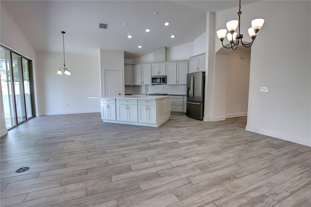 1727 Butterfly Way, Longwood, FL 32750 - kitchen featuring stainless steel appliances, a chandelier, open floor plan, high vaulted ceiling, and recessed lighting