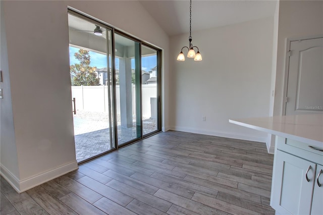 1727 Butterfly Way, Longwood, FL 32750 - unfurnished dining area with light wood finished floors, a chandelier, baseboards, and lofted ceiling
