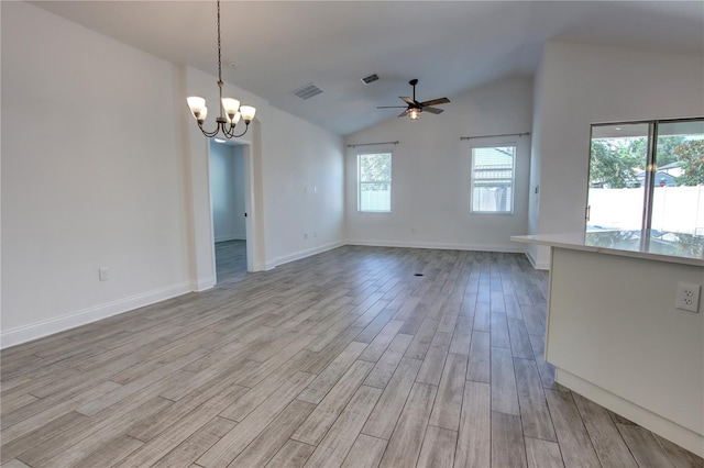 1727 Butterfly Way, Longwood, FL 32750 - spare room with light wood-style floors, a ceiling fan, a chandelier, vaulted ceiling, and baseboards