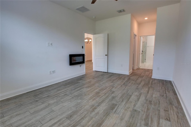 1727 Butterfly Way, Longwood, FL 32750 - empty room with ceiling fan, a chandelier, wood finished floors, baseboards, and recessed lighting