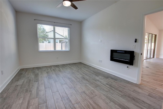 1727 Butterfly Way, Longwood, FL 32750 - empty room featuring wood finished floors, ceiling fan, heating unit, a glass covered fireplace, and baseboards