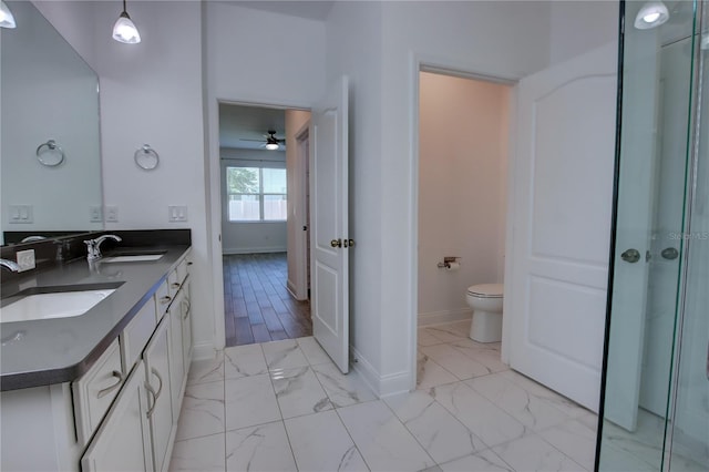 1727 Butterfly Way, Longwood, FL 32750 - bathroom with marble finish floors, double vanity, toilet, and baseboards