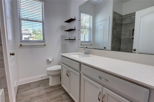 1727 Butterfly Way, Longwood, FL 32750 - full bathroom with toilet, vanity, tiled shower, baseboards, and wood finished floors