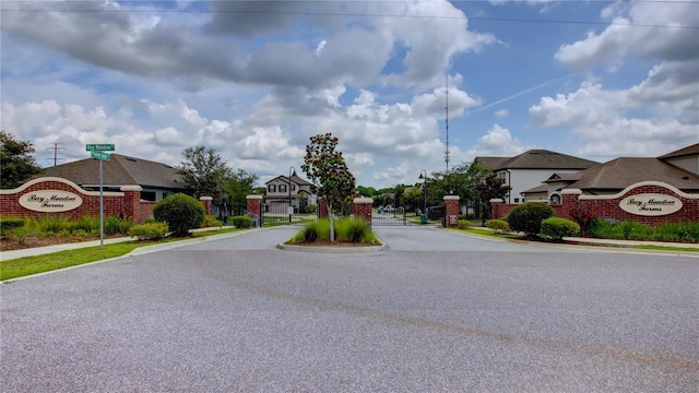 1727 Butterfly Way, Longwood, FL 32750 - view of asphalt street with sidewalks, curbs, a gated entry, and a residential view
