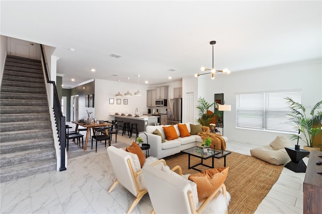 4184 Paragraph Dr, Kissimmee, FL 34746 - living room featuring light marble finish floors, stairs, recessed lighting, ornamental molding, and a chandelier