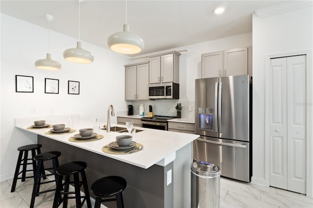 4184 Paragraph Dr, Kissimmee, FL 34746 - kitchen with stainless steel appliances, light marble finish floors, a sink, and a breakfast bar area