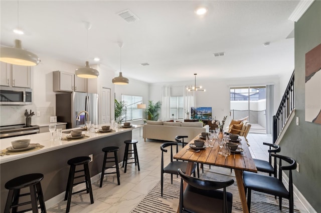 4184 Paragraph Dr, Kissimmee, FL 34746 - dining area featuring light marble finish flooring, a chandelier, and recessed lighting