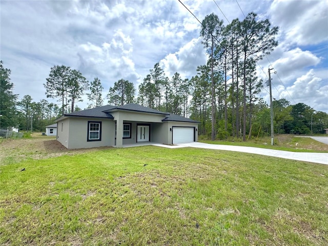 628 W Heronsbill Ln, Dunnellon, FL 34434 - view of front of property with driveway, a garage, stucco siding, and a front lawn