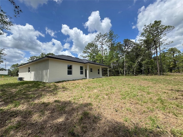 2523 W Andromedae Dr, Citrus Springs, FL 34433 - back of property featuring stucco siding and a yard