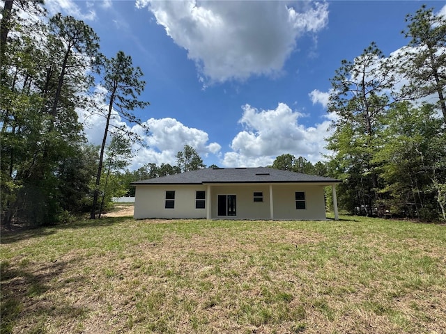 2523 W Andromedae Dr, Citrus Springs, FL 34433 - rear view of property featuring a lawn and stucco siding