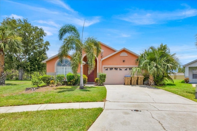 2627 Autumn Creek Cir, Kissimmee, FL 34747 - view of front of house featuring an attached garage, concrete driveway, a front yard, and stucco siding