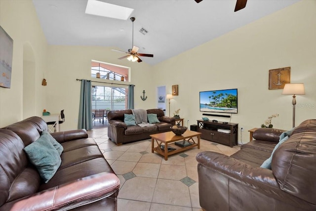 2627 Autumn Creek Cir, Kissimmee, FL 34747 - living room featuring a ceiling fan, high vaulted ceiling, light tile patterned floors, a skylight, and arched walkways