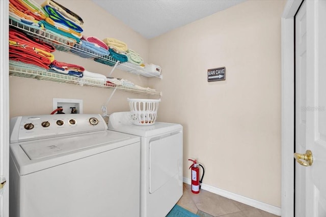 2627 Autumn Creek Cir, Kissimmee, FL 34747 - washroom with separate washer and dryer, baseboards, and light tile patterned floors