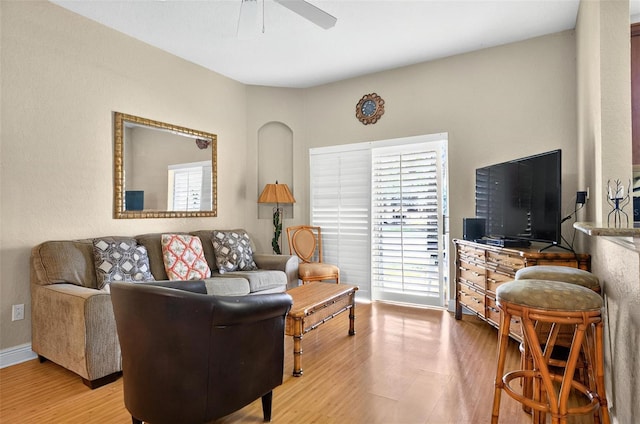 3725 Calabria Ave, Davenport, FL 33897 - living area featuring a ceiling fan, light wood finished floors, and baseboards