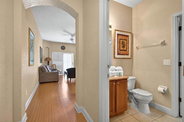 3725 Calabria Ave, Davenport, FL 33897 - bathroom with toilet, a ceiling fan, vanity, baseboards, and a textured wall