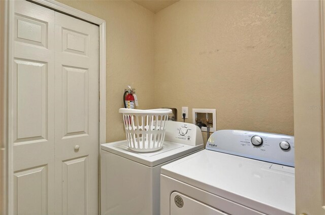 3725 Calabria Ave, Davenport, FL 33897 - laundry room featuring independent washer and dryer and a textured wall