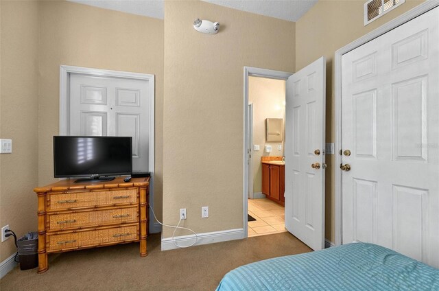 3725 Calabria Ave, Davenport, FL 33897 - carpeted bedroom with baseboards and connected bathroom