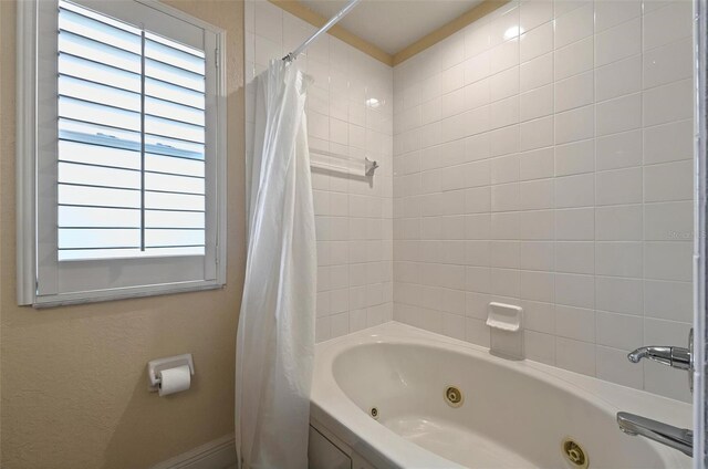 3725 Calabria Ave, Davenport, FL 33897 - full bathroom featuring healthy amount of natural light, a combined bath / shower with jetted tub, and baseboards