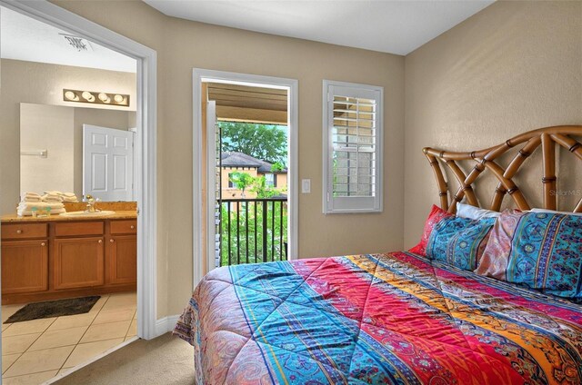 3725 Calabria Ave, Davenport, FL 33897 - bedroom with a sink, access to outside, light carpet, light tile patterned floors, and ensuite bath