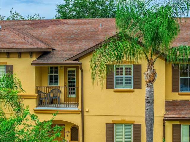 3725 Calabria Ave, Davenport, FL 33897 - view of front of house with stucco siding and a balcony