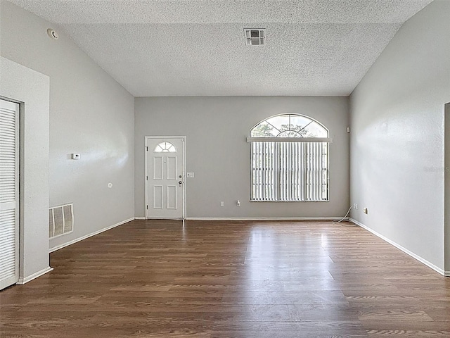 7337 Cone Shell Dr, Spring Hill, FL 34607 - foyer entrance featuring dark wood finished floors, a textured ceiling, and baseboards