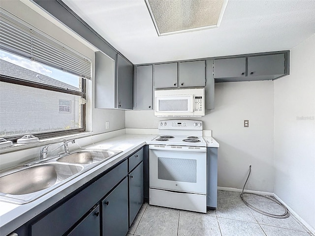 7337 Cone Shell Dr, Spring Hill, FL 34607 - kitchen with white appliances, gray cabinetry, a sink, and baseboards