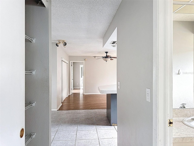 7337 Cone Shell Dr, Spring Hill, FL 34607 - hall with light tile patterned flooring and a textured ceiling