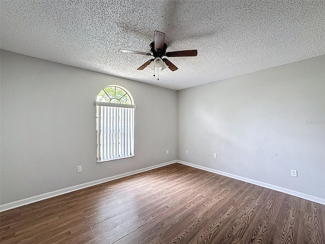 7337 Cone Shell Dr, Spring Hill, FL 34607 - empty room with a ceiling fan, dark wood finished floors, a textured ceiling, and baseboards