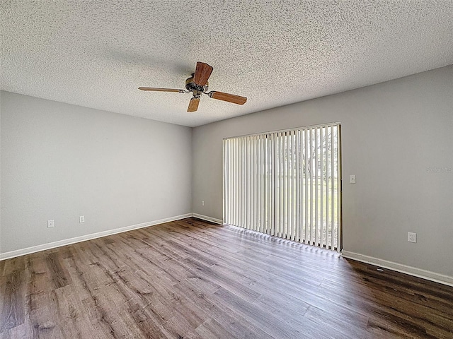 7337 Cone Shell Dr, Spring Hill, FL 34607 - empty room featuring wood finished floors, a ceiling fan, baseboards, and a textured ceiling
