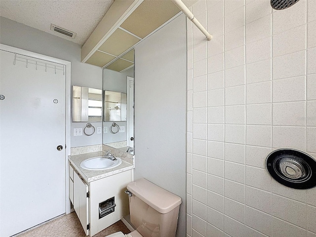 7337 Cone Shell Dr, Spring Hill, FL 34607 - full bath with toilet, vanity, a tile shower, and a textured ceiling