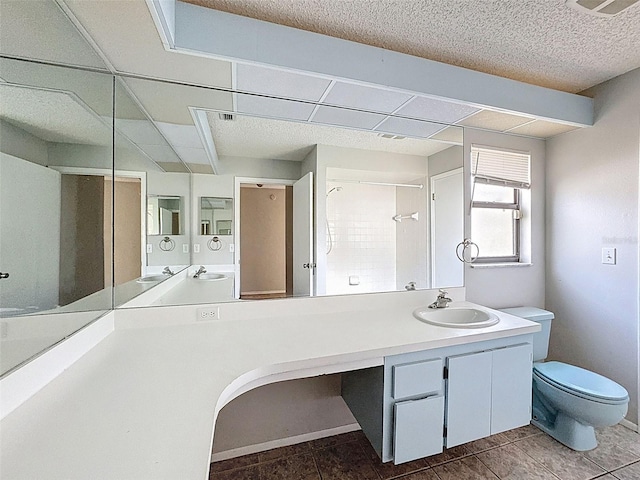 7337 Cone Shell Dr, Spring Hill, FL 34607 - full bathroom featuring toilet, vanity, a textured ceiling, and tile patterned flooring