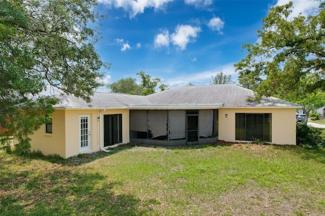 7337 Cone Shell Dr, Spring Hill, FL 34607 - back of property with a sunroom, a lawn, and stucco siding