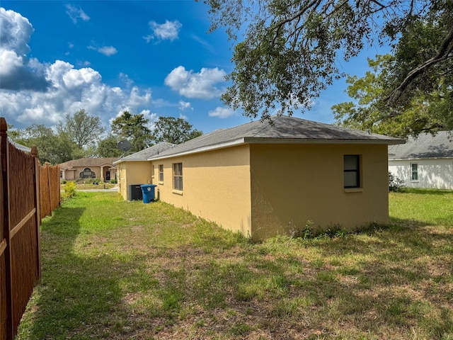 7337 Cone Shell Dr, Spring Hill, FL 34607 - view of home's exterior with stucco siding and central AC unit