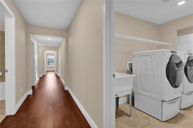8348 Vivaro Isle Way, Windermere, FL 34786 - washroom featuring independent washer and dryer, baseboards, wood finished floors, and recessed lighting