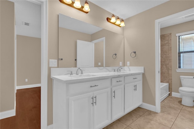 8348 Vivaro Isle Way, Windermere, FL 34786 - bathroom with double vanity, toilet, baseboards, and shower / tub combination