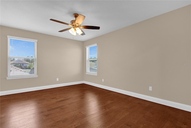 8348 Vivaro Isle Way, Windermere, FL 34786 - empty room with dark wood finished floors, baseboards, and ceiling fan