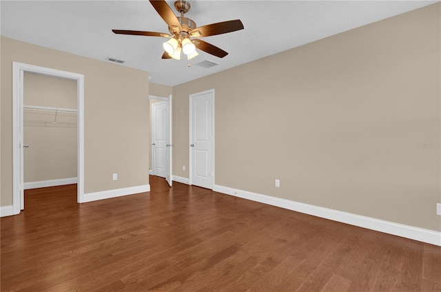 8348 Vivaro Isle Way, Windermere, FL 34786 - unfurnished bedroom with baseboards, wood finished floors, a spacious closet, and a closet