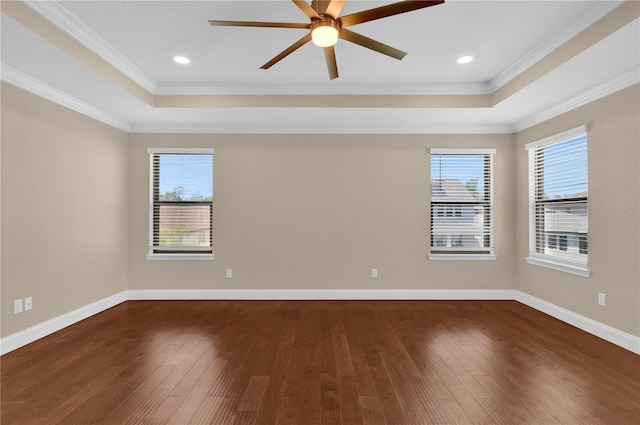 8348 Vivaro Isle Way, Windermere, FL 34786 - empty room featuring a raised ceiling, dark wood-style flooring, ornamental molding, a ceiling fan, and baseboards