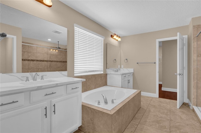 8348 Vivaro Isle Way, Windermere, FL 34786 - bathroom with a stall shower, two vanities, a bath, tile patterned floors, and a walk in closet