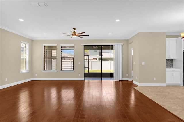8348 Vivaro Isle Way, Windermere, FL 34786 - unfurnished living room featuring hardwood / wood-style flooring, a ceiling fan, crown molding, baseboards, and recessed lighting