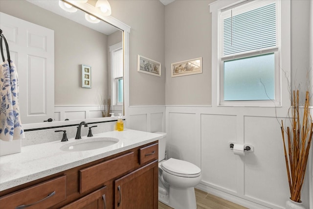 9846 SW 106th Ct, Ocala, F, Ocala, FL 34481 - half bath with vanity, a decorative wall, wainscoting, and wood finished floors