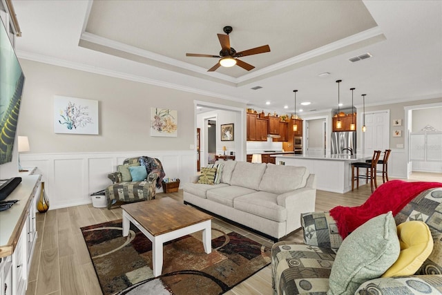 9846 SW 106th Ct, Ocala, F, Ocala, FL 34481 - living room with a tray ceiling, ceiling fan, light wood-style flooring, crown molding, and recessed lighting