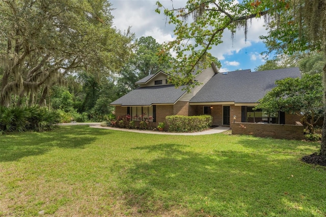120 E Greentree Ln, Lake Mary, FL 32746 - view of front of home featuring a front yard, brick siding, and a shingled roof