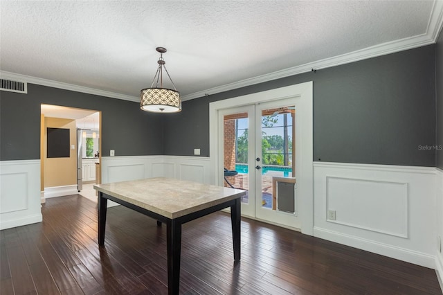 120 E Greentree Ln, Lake Mary, FL 32746 - dining area with french doors, a wainscoted wall, a textured ceiling, crown molding, and dark wood finished floors