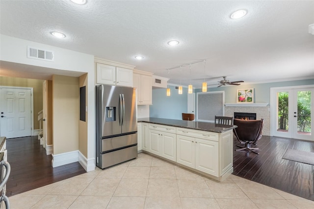 120 E Greentree Ln, Lake Mary, FL 32746 - kitchen with stainless steel fridge, a peninsula, ceiling fan, a textured ceiling, and baseboards