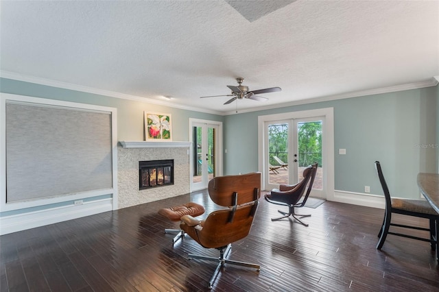 120 E Greentree Ln, Lake Mary, FL 32746 - living area with a fireplace, french doors, baseboards, wood finished floors, and a textured ceiling