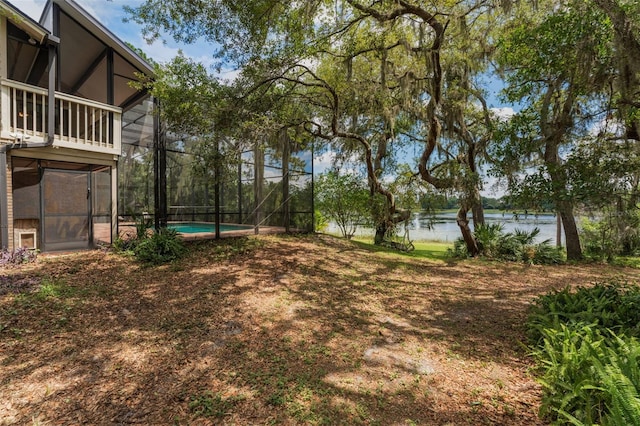120 E Greentree Ln, Lake Mary, FL 32746 - view of yard featuring a water view, an outdoor pool, and glass enclosure